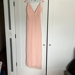 Bridesmaid dress by Lulus. Pastel pink, pleated, criss cross back